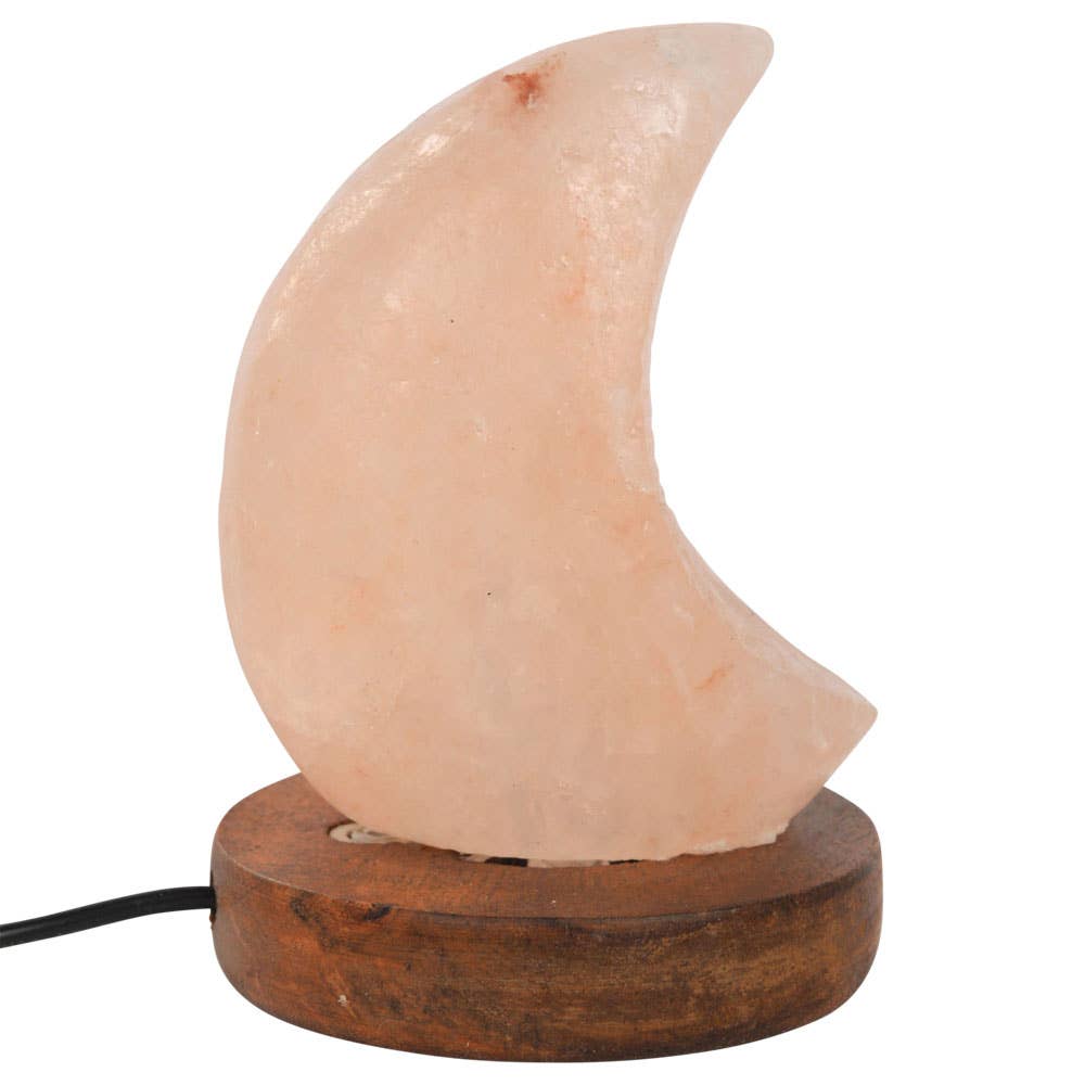 Himalayan salt lamp shaped like a crescent moon on a wooden base