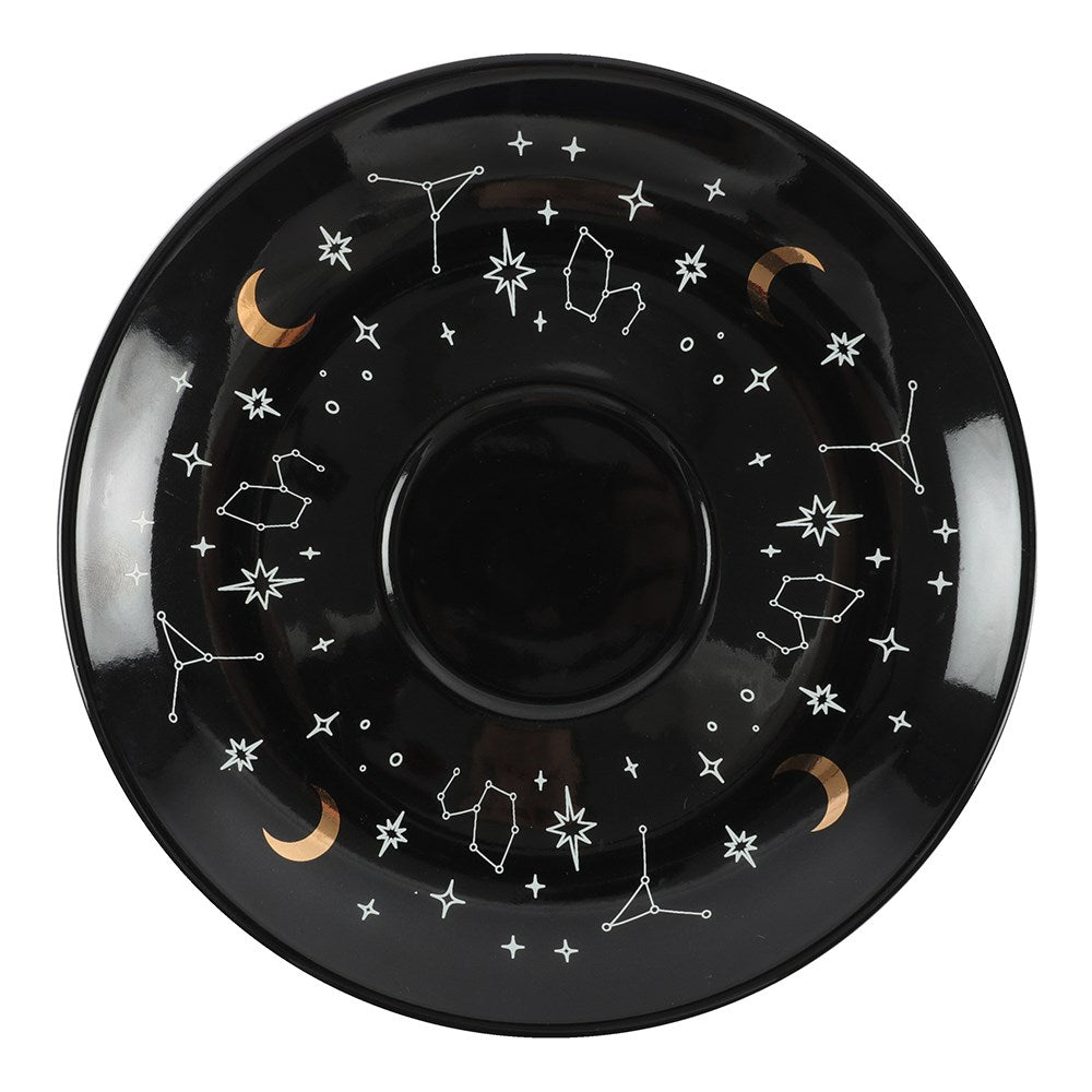Black ceramic plate with star and constellation designs on a white background