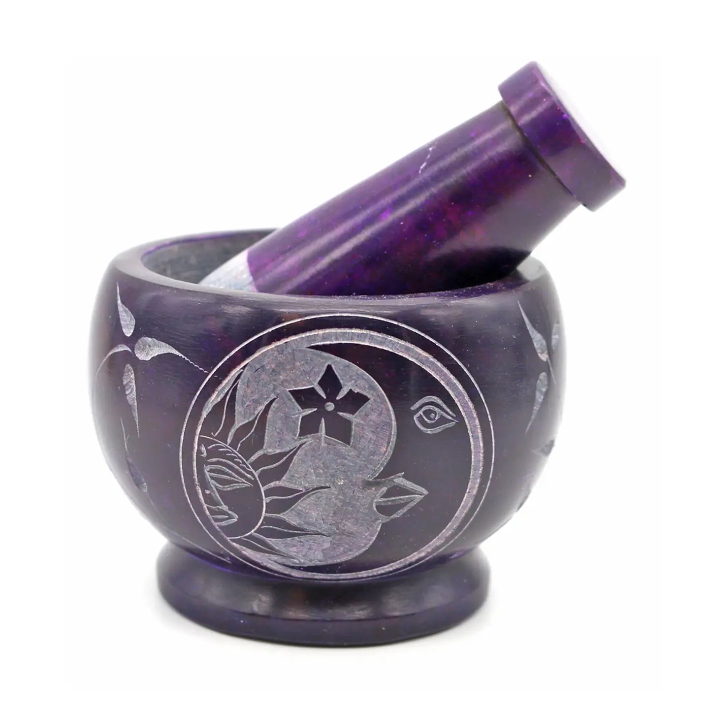 Purple mortar and pestle with engraved design on a white background
