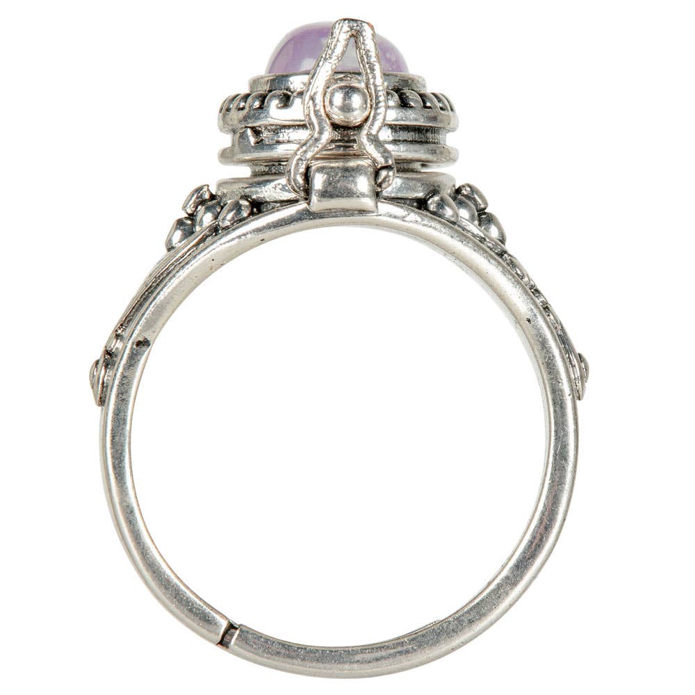 Silver ring with a purple gemstone on a white background