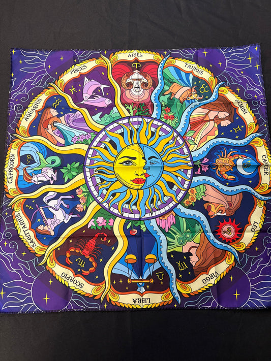 Colorful zodiac art piece with a central sun and moon design on a dark background