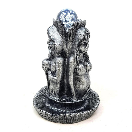 Decorative stand with mother maiden crone and a crystal ball on a white background