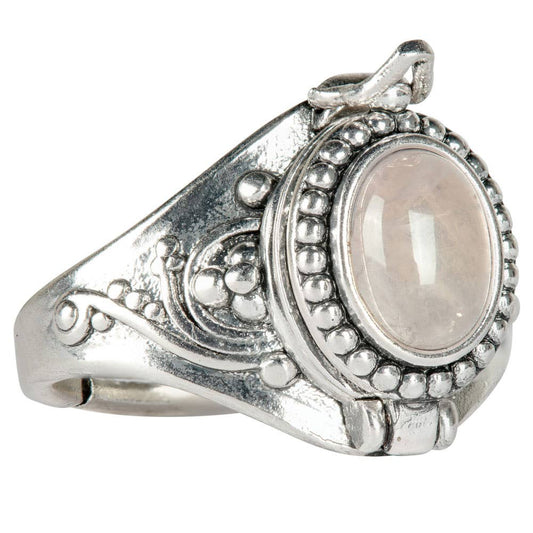 Silver ring with a central gemstone on a white background