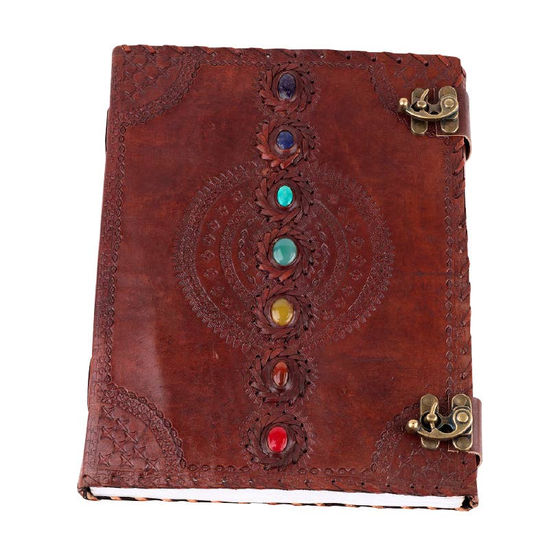 Brown leather journal with chakra stones and gold clasp on a white background