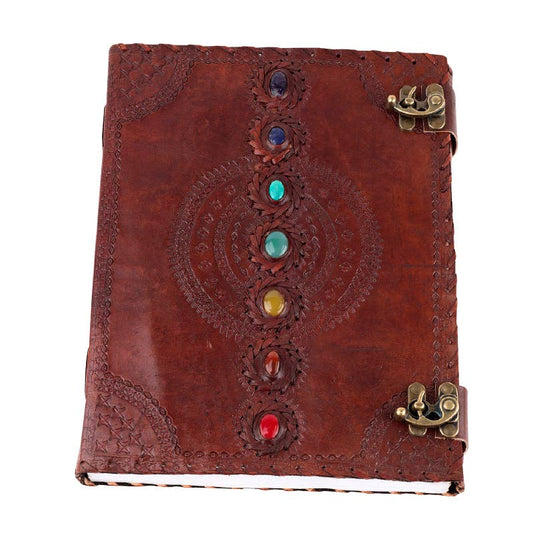 Brown leather journal with chakra stones and gold clasp on a white background