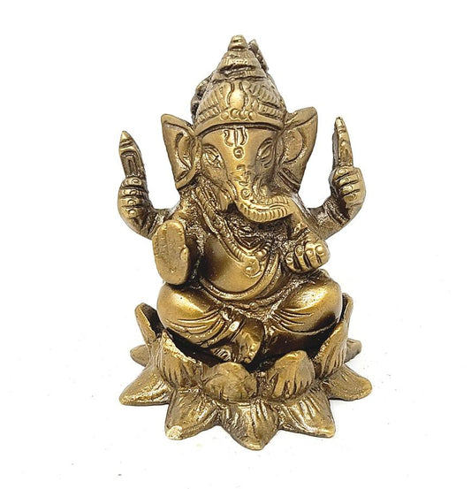 Brass statue of a seated deity on a white background
