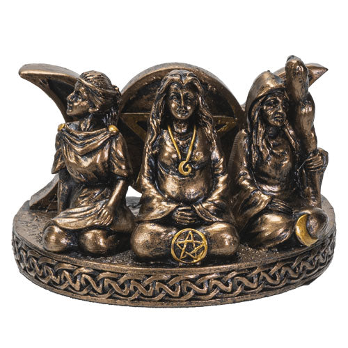 Bronze figurine of three seated figures with a central figure holding a pentacle symbol on a white background.