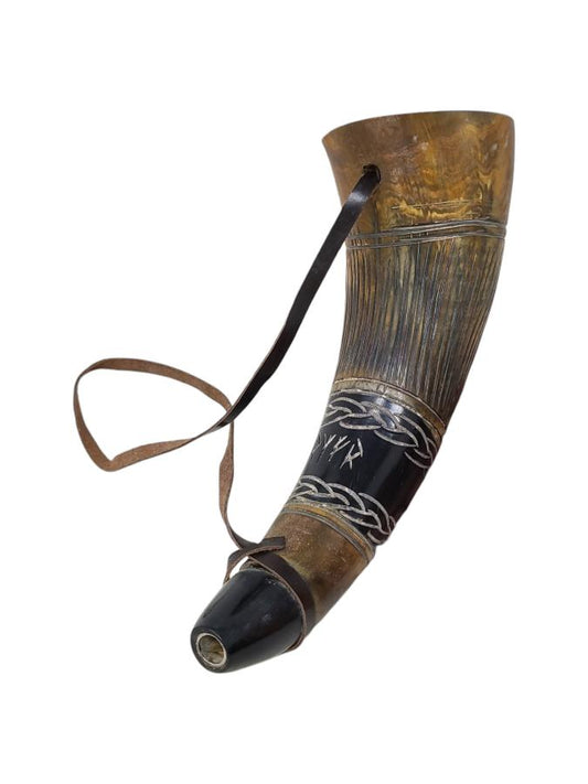 Decorative horn with black band and white design on a white background